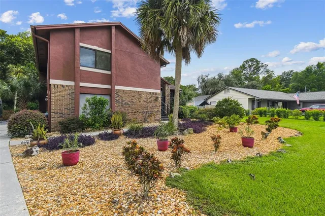 a view of a house with backyard and sitting area