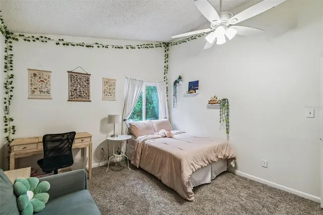 a bedroom with a bed couch and window