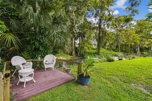 a view of a patio with furniture and umbrella