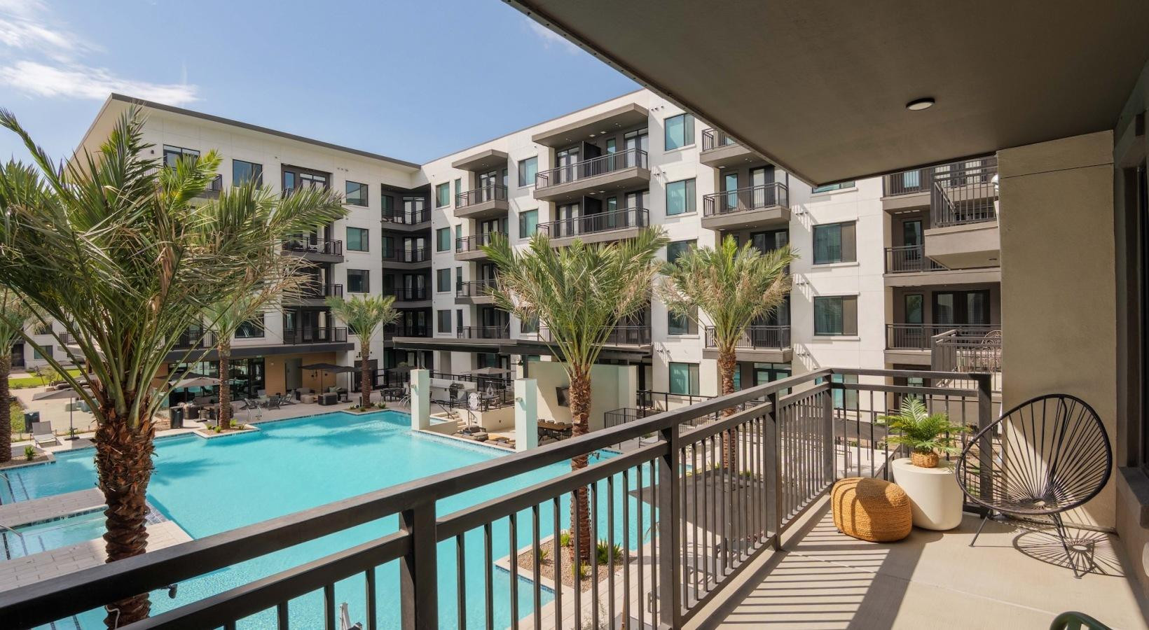 500 East Rivulon Boulevard, Unit C1 Gilbert, AZ 85297 - Photo 31 of 33 a view of a balcony with chairs and wooden fence