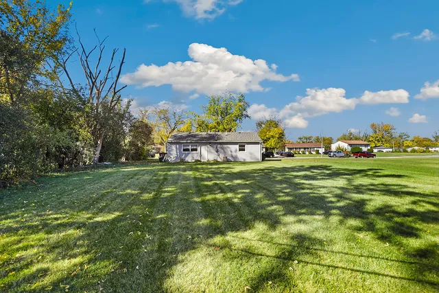 a view of an house with backyard space and garden
