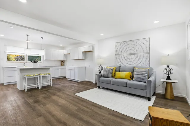 a living room with furniture and kitchen view