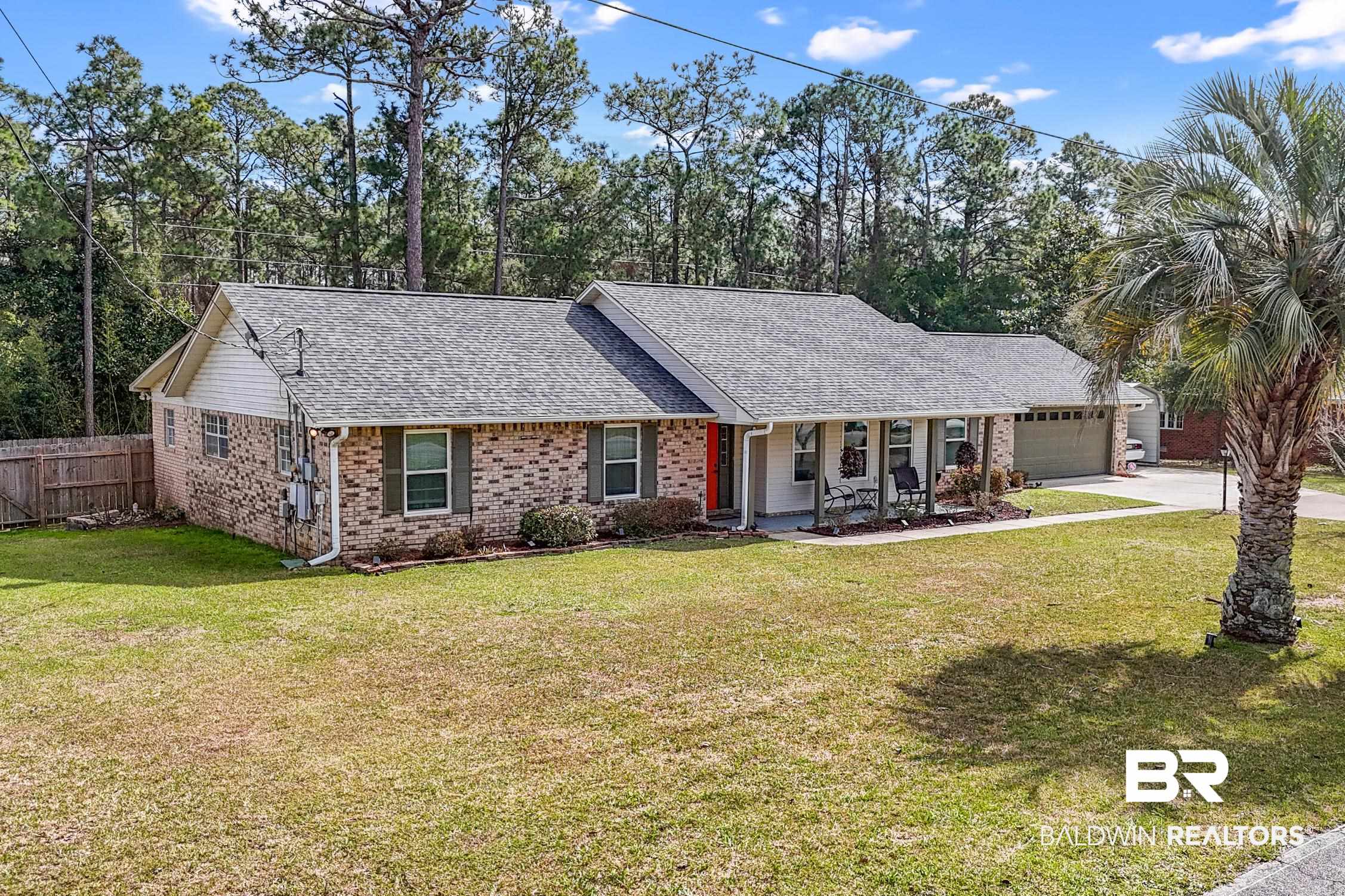 2553 Santa Rosa Drive Lillian, AL 36549 - Photo 45 of 51 Ranch-style house featuring a garage, a shingled roof, fence, a front lawn, and brick siding
