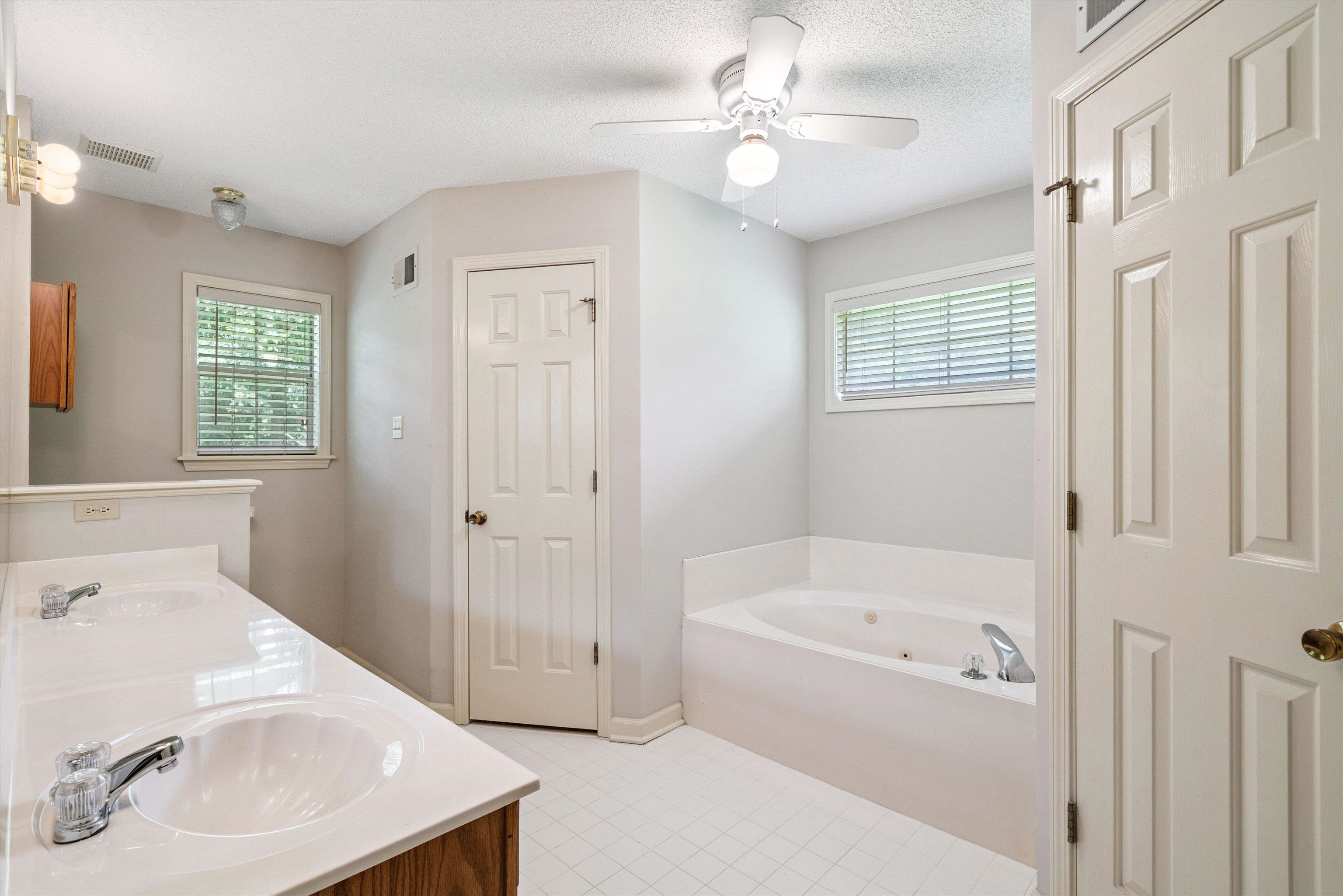 3365 Tomlin Road Somerville, TN 38068 - Photo 18 of 29 a bathroom with a sink a bathtub and a window