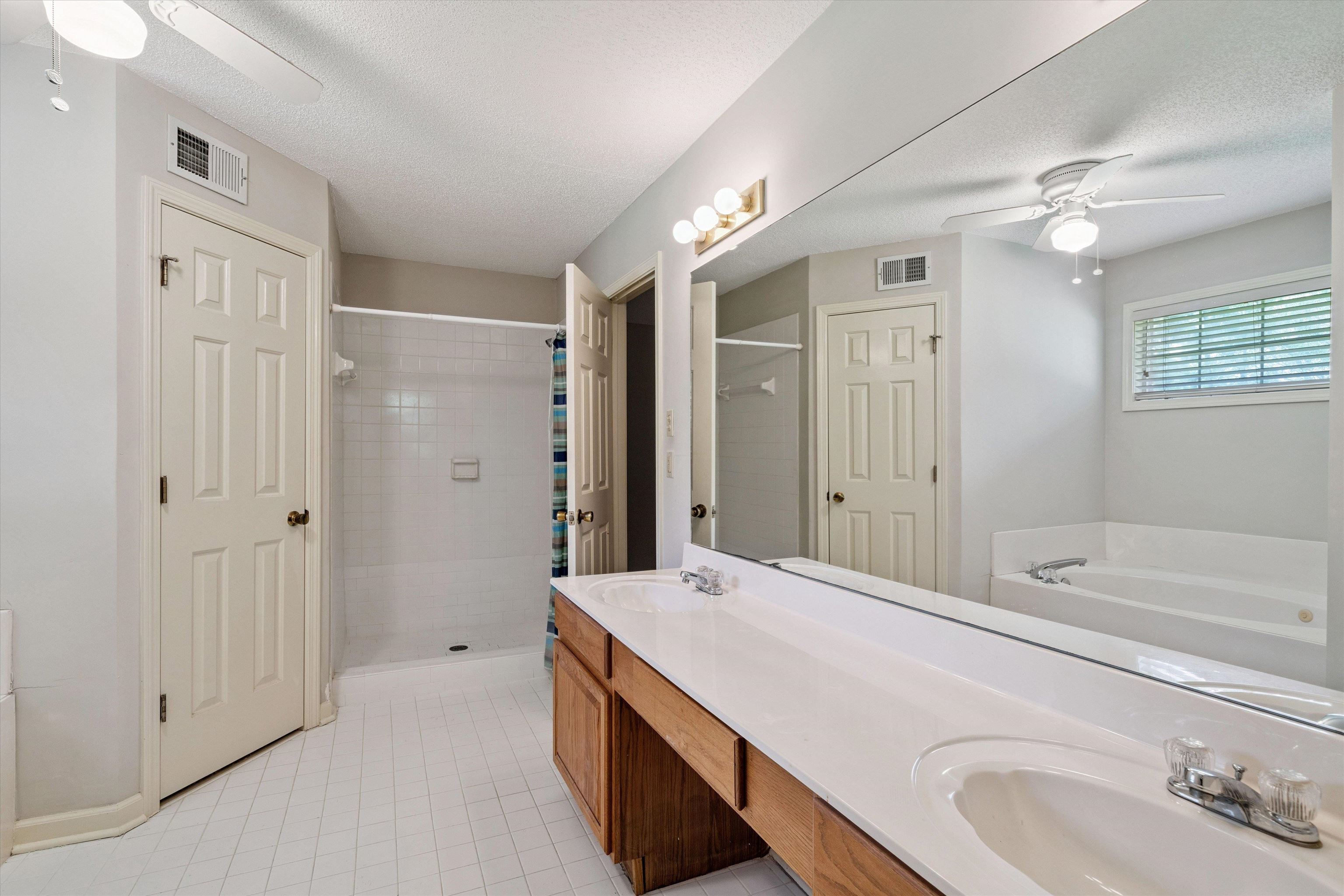 3365 Tomlin Road Somerville, TN 38068 - Photo 19 of 29 a bathroom with a tub sink double and mirror