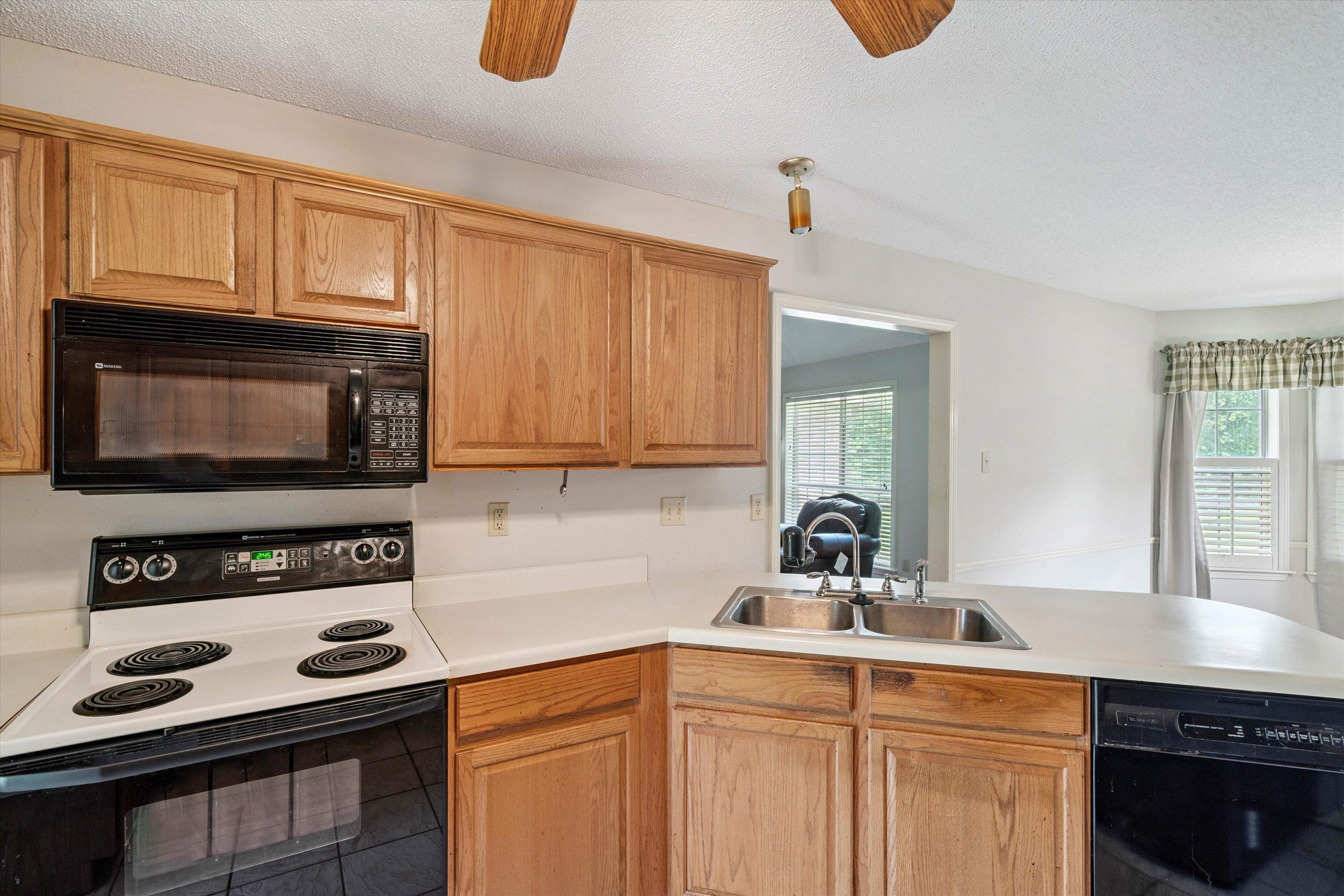3365 Tomlin Road Somerville, TN 38068 - Photo 9 of 29 a kitchen with stainless steel appliances a stove a sink and a microwave