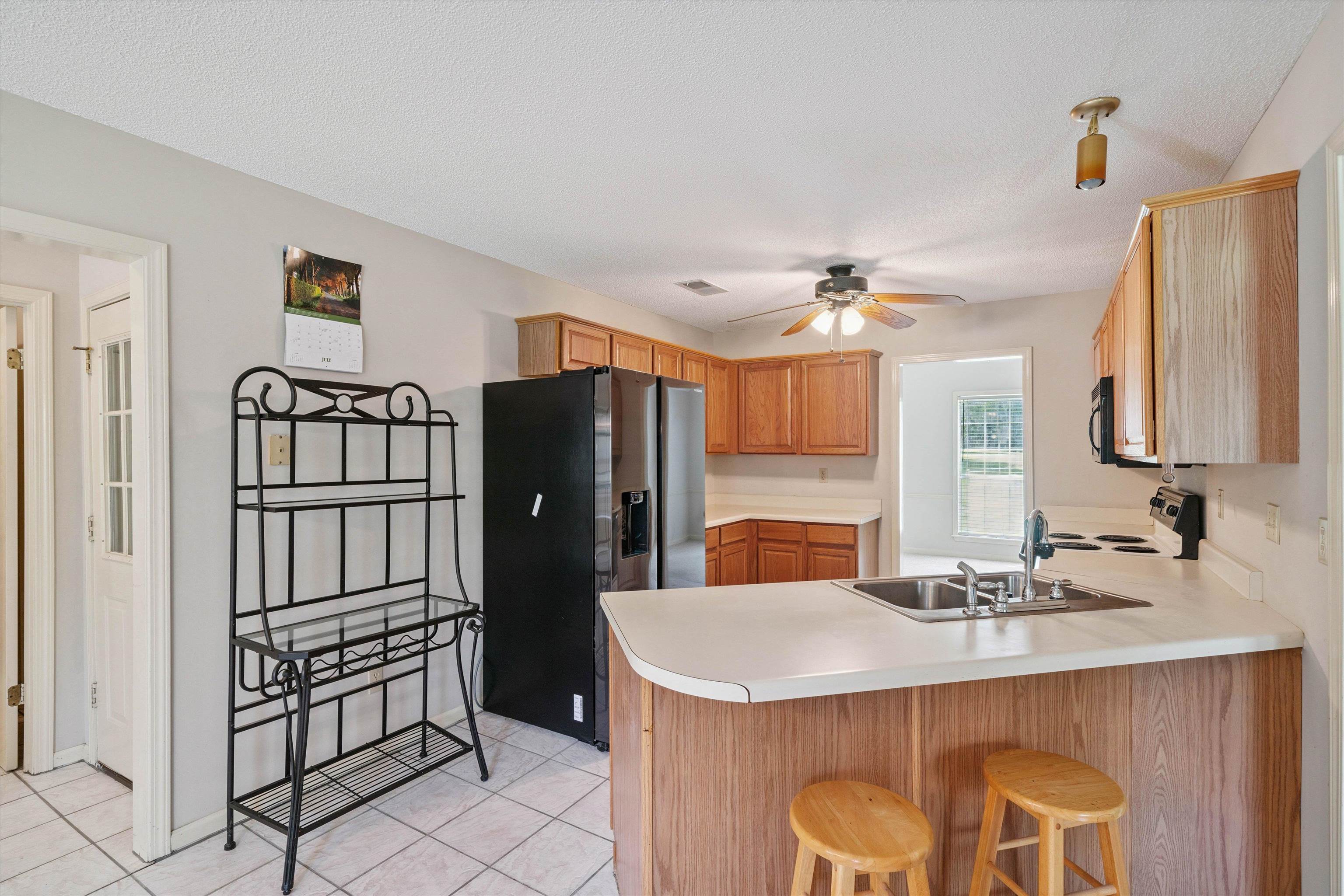 3365 Tomlin Road Somerville, TN 38068 - Photo 10 of 29 a kitchen with a refrigerator a sink and dishwasher with wooden floor