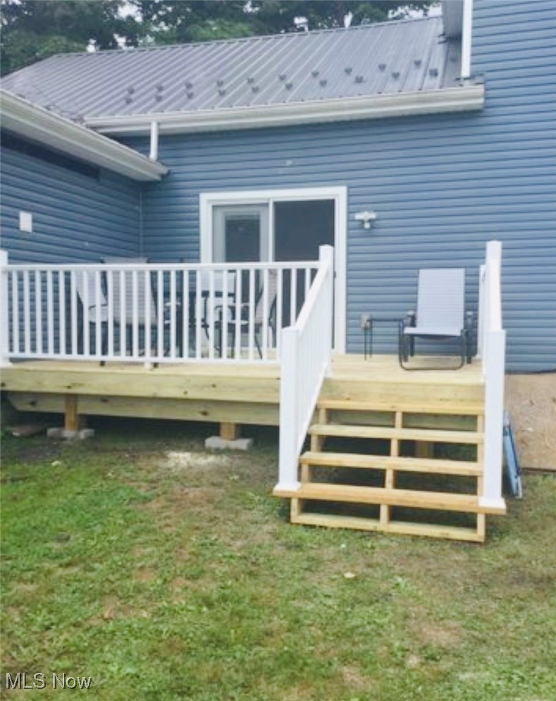 436 Keefus Road Conneaut, OH 44030 - Photo 23 of 30 Rear view of property with a metal roof, a deck, and a yard