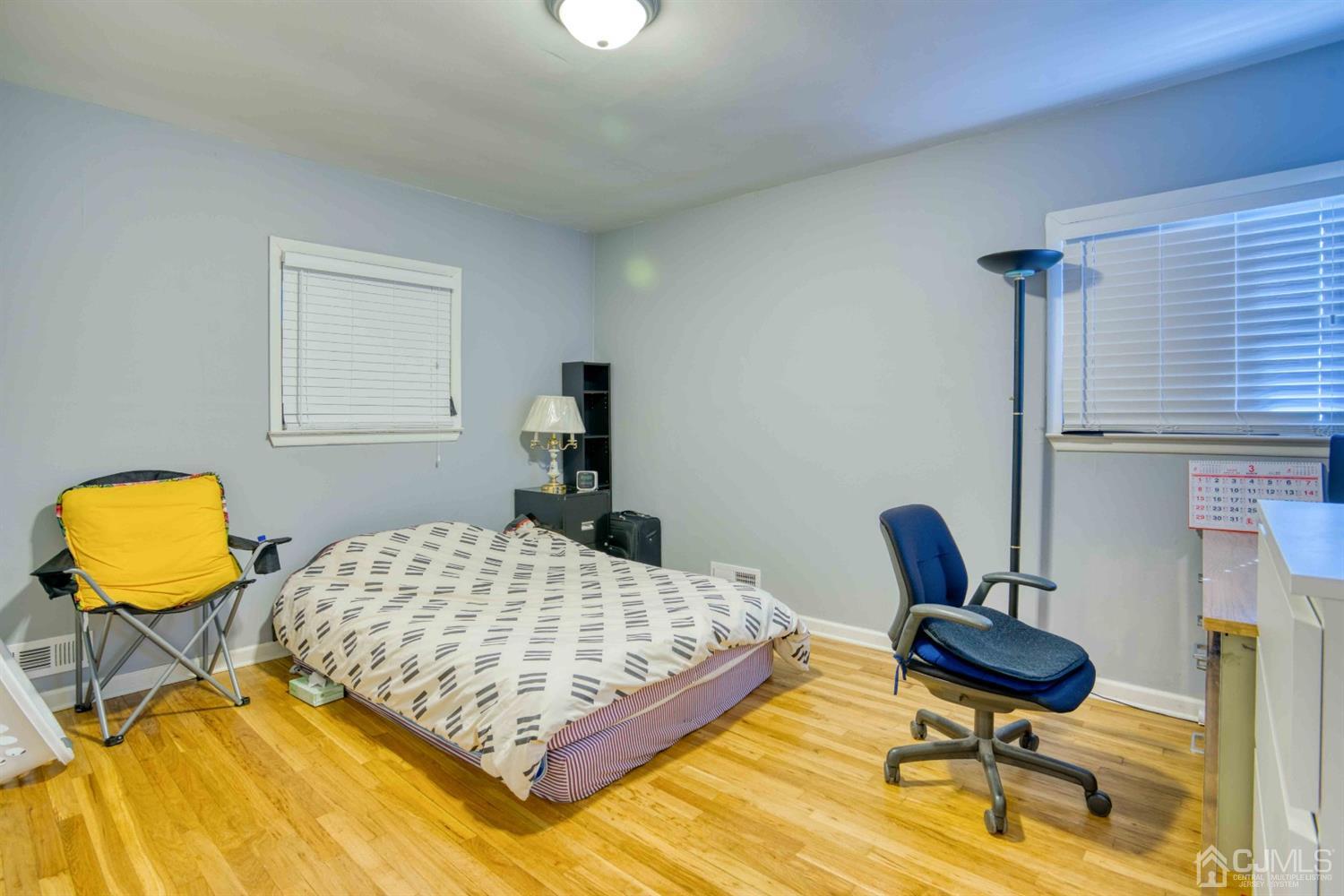 19 Hill Road Edison, NJ 08817 - Photo 11 of 19 a bedroom with a bed and chair