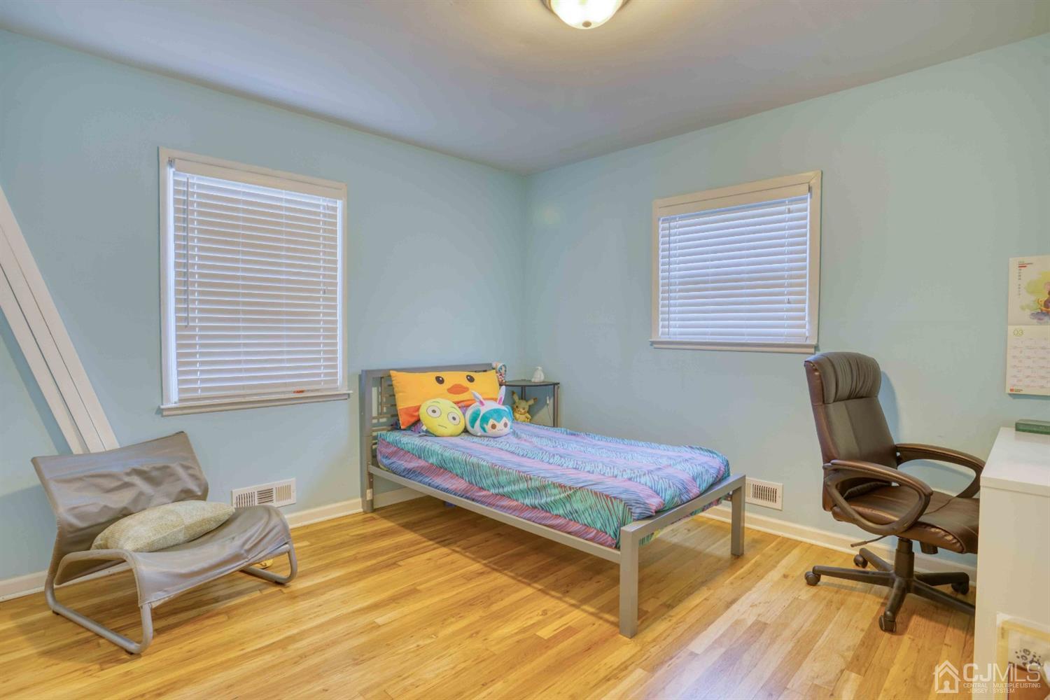 19 Hill Road Edison, NJ 08817 - Photo 12 of 19 a bedroom with a bed and wooden floor