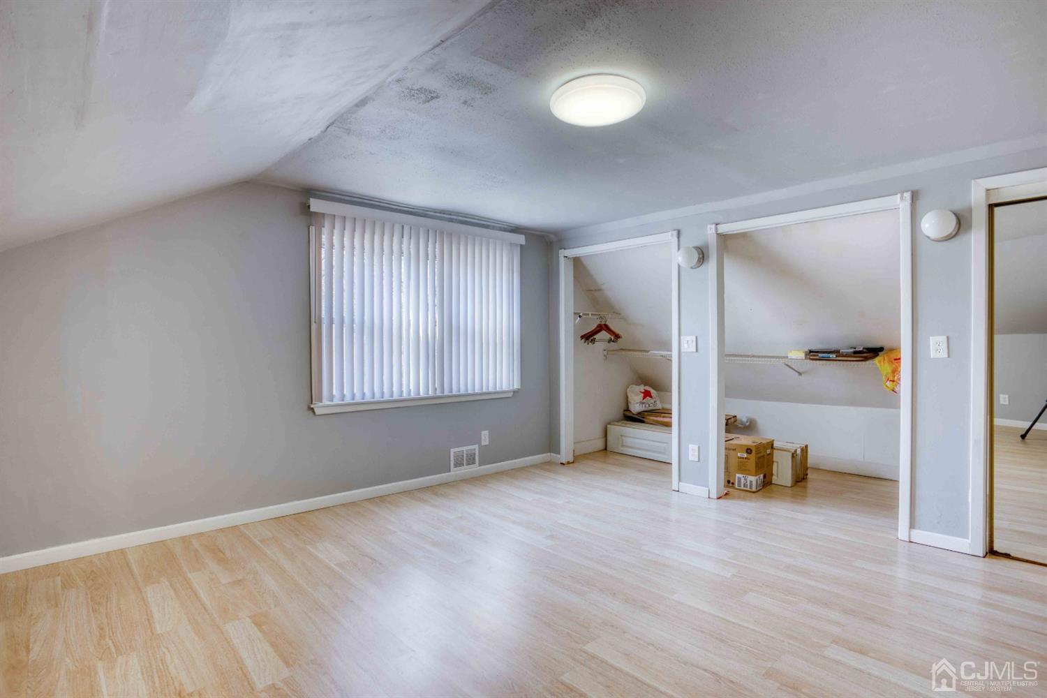 19 Hill Road Edison, NJ 08817 - Photo 15 of 19 a view of an empty room with wooden floor and a window