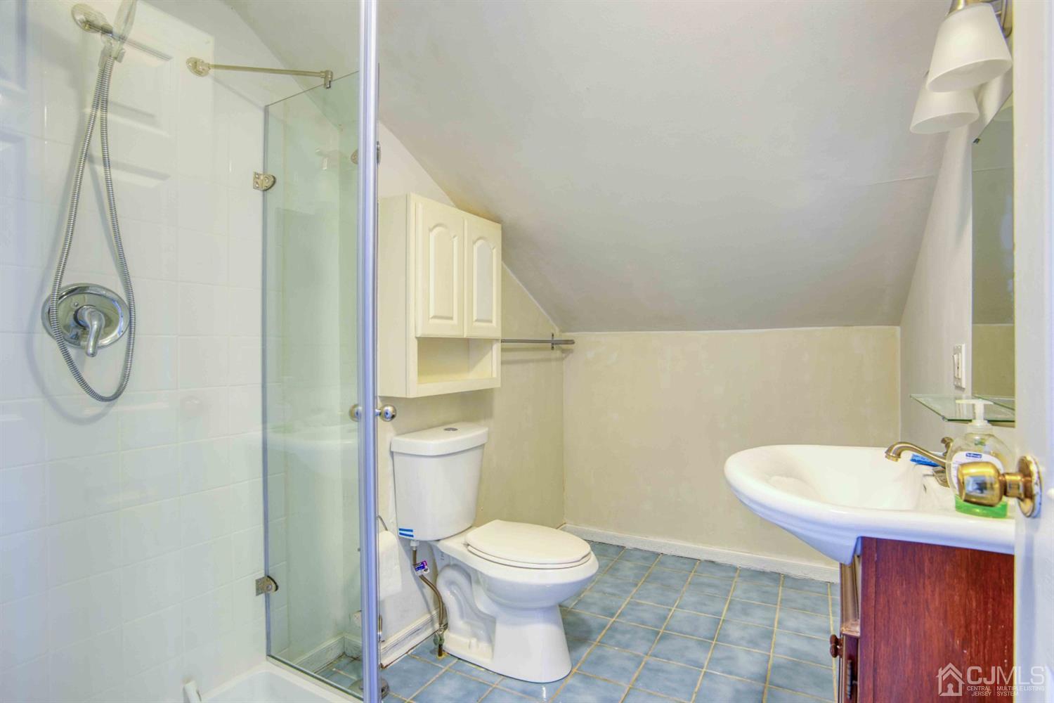 19 Hill Road Edison, NJ 08817 - Photo 16 of 19 a bathroom with a toilet a sink and shower