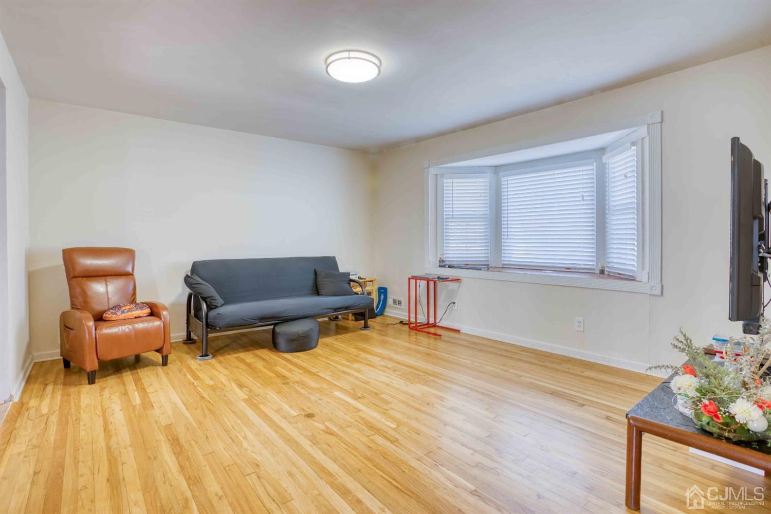 19 Hill Road Edison, NJ 08817 - Photo 3 of 19 a living room with furniture and a flat screen tv