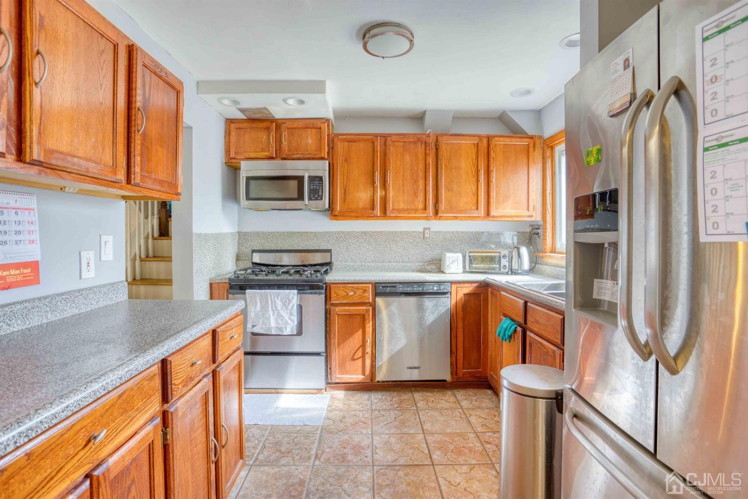 19 Hill Road Edison, NJ 08817 - Photo 6 of 19 a kitchen with stainless steel appliances granite countertop a stove a sink and a refrigerator