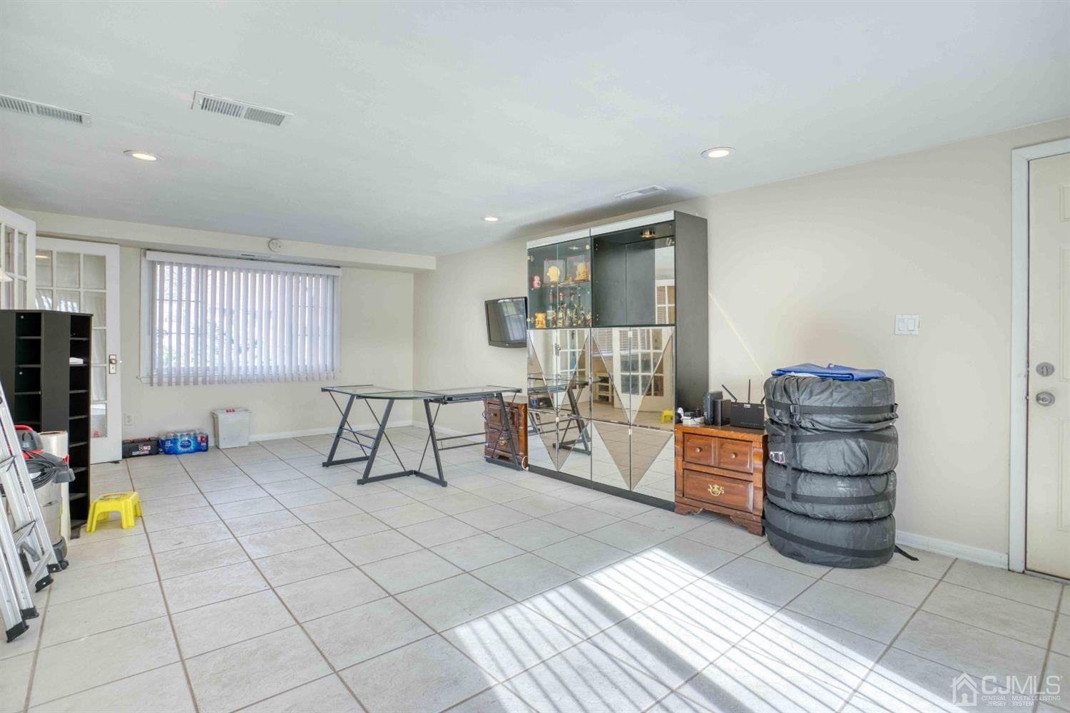 19 Hill Road Edison, NJ 08817 - Photo 9 of 19 a living room with furniture a dining table and a flat screen tv