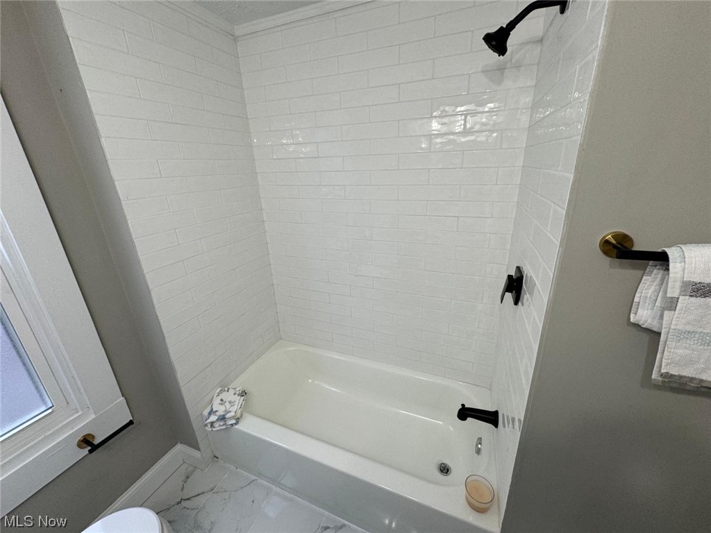 3333 Berea Road Cleveland, OH 44111 - Photo 18 of 34 Bathroom with tiled shower / bath, toilet, and tile flooring