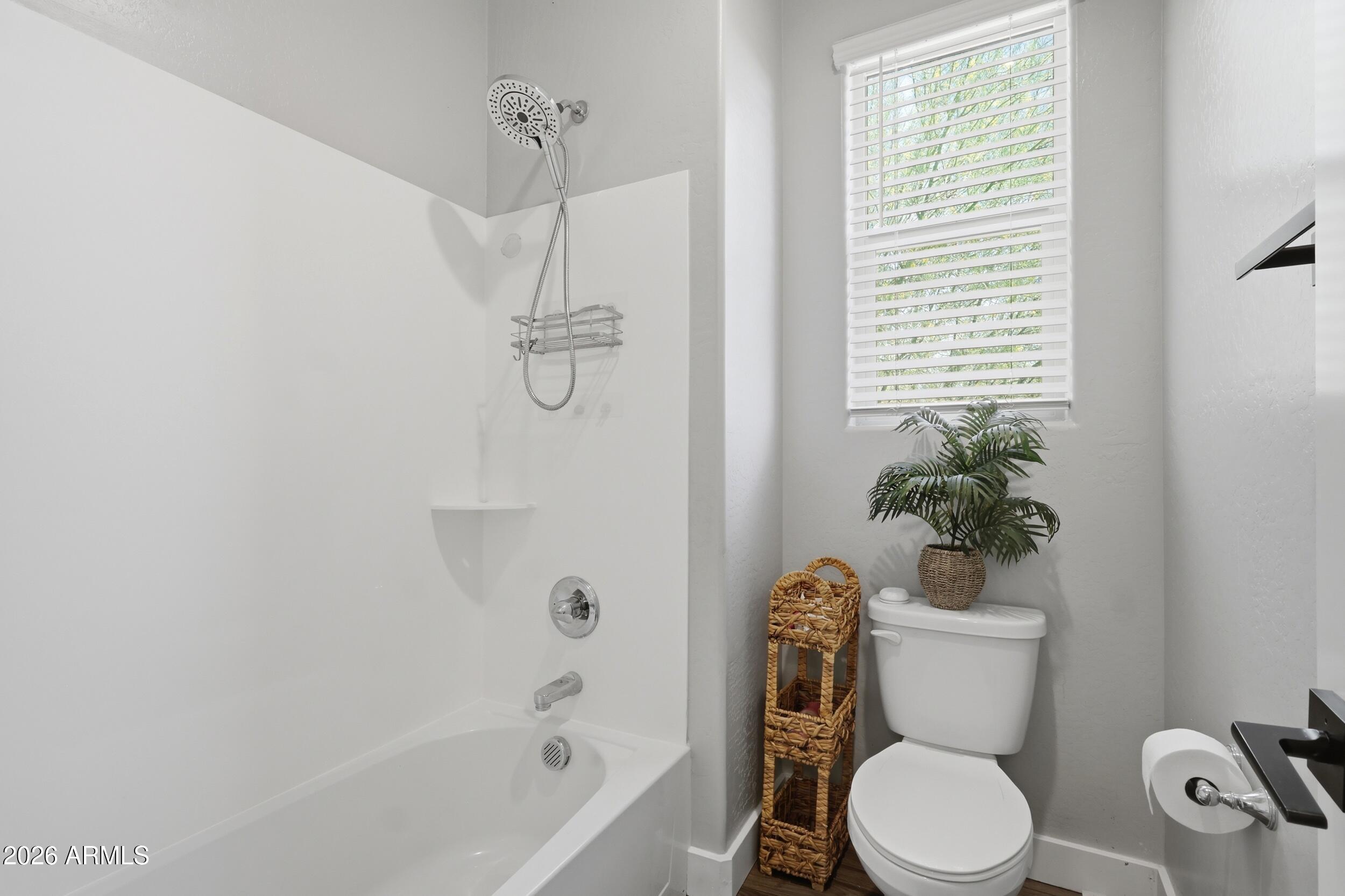 12517 West Lawrence Road Glendale, AZ 85307 - Photo 45 of 52 a white toilet sitting next to a bath tub
