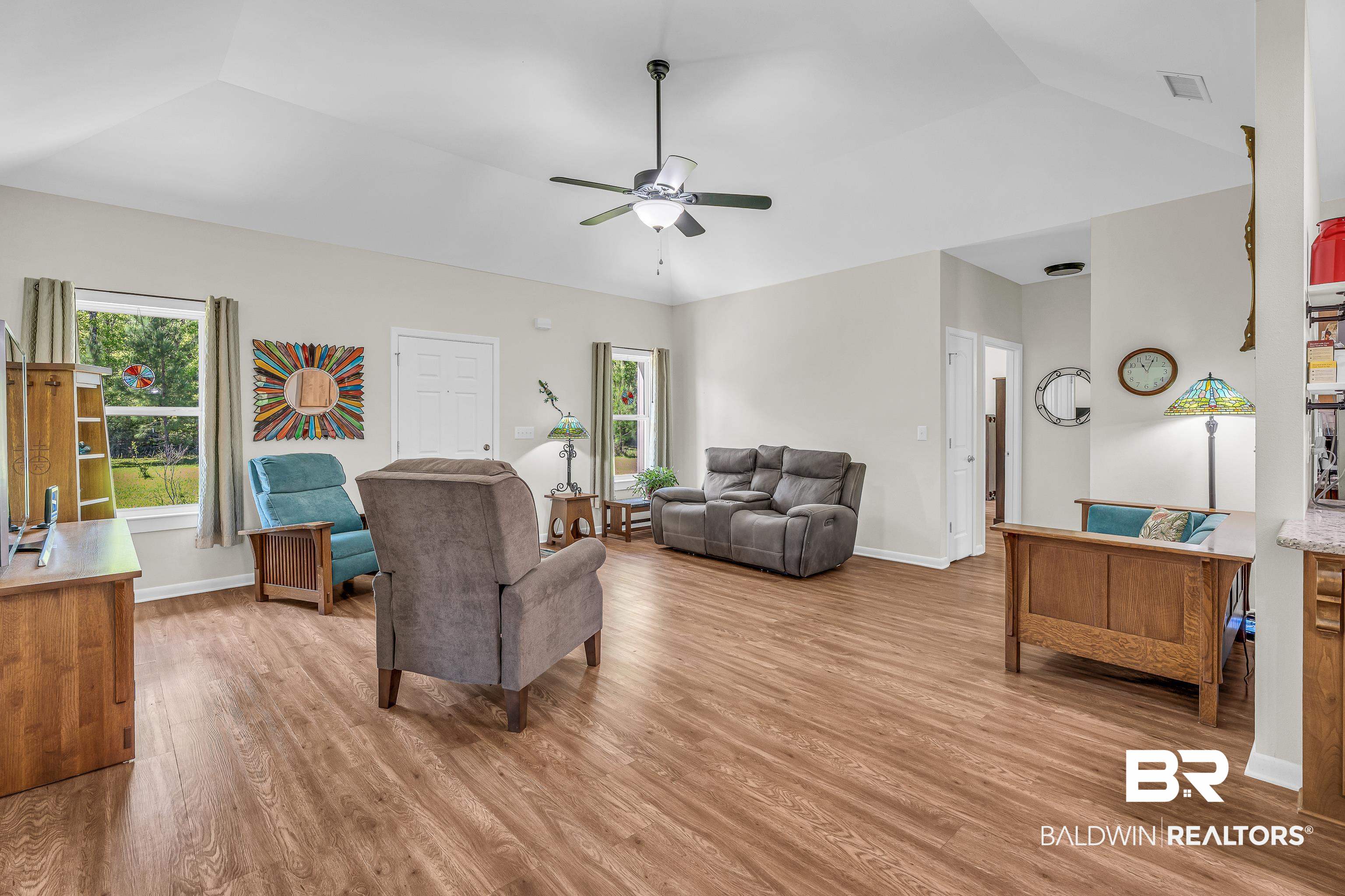 18255 Cactus Court Elberta, AL 36530 - Photo 13 of 53 Living area with ceiling fan, light wood finished floors, plenty of natural light, and lofted ceiling