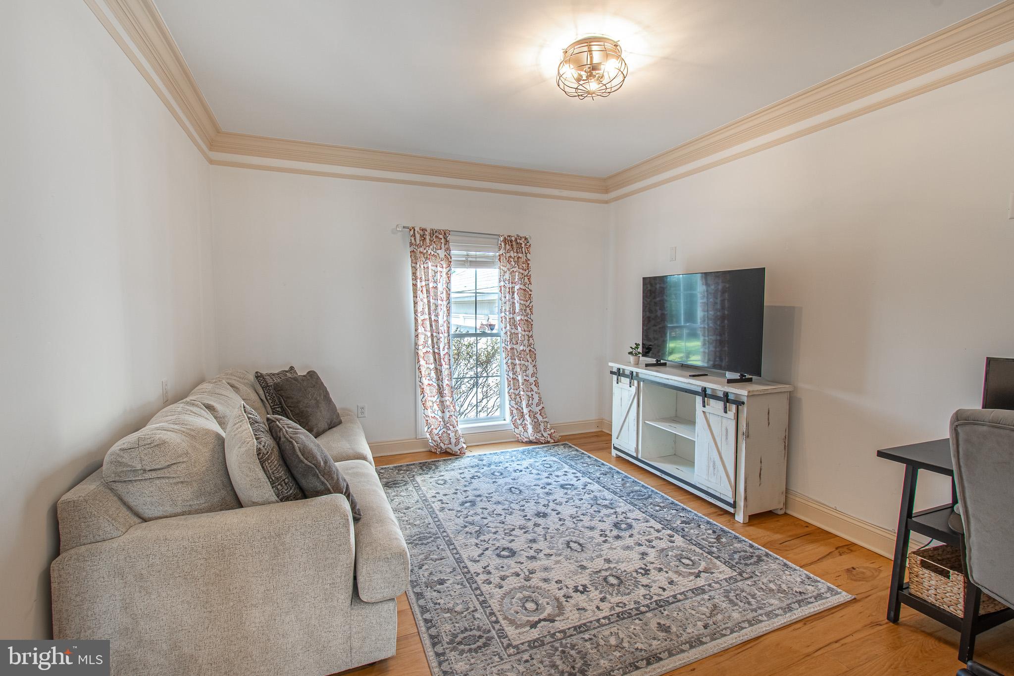 5227 Brooks Road Woolford, MD 21677 - Photo 14 of 68 a living room with furniture and a flat screen tv
