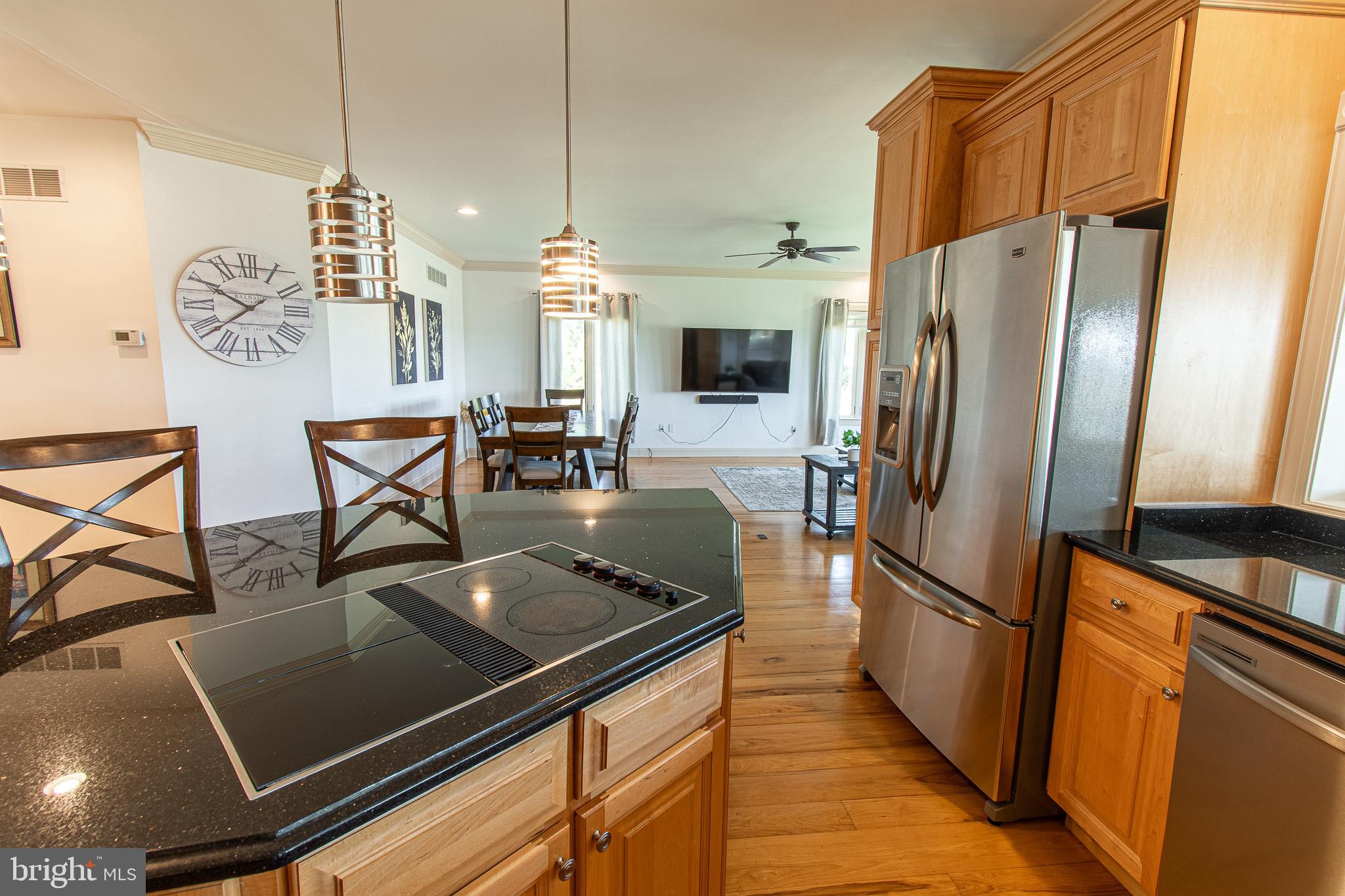 5227 Brooks Road Woolford, MD 21677 - Photo 18 of 68 a kitchen with stainless steel appliances a refrigerator a stove a sink and chairs