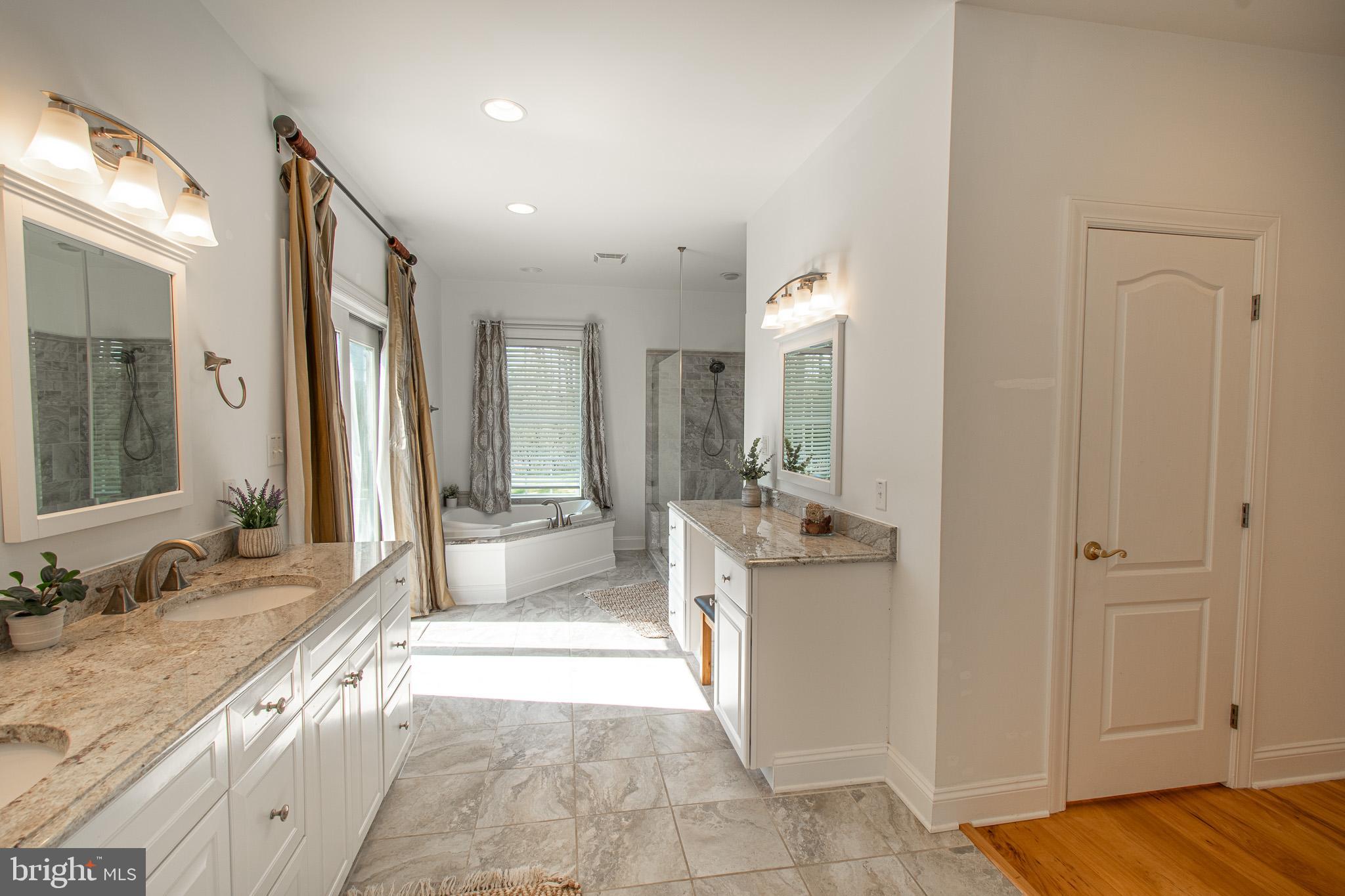 5227 Brooks Road Woolford, MD 21677 - Photo 33 of 68 a spacious bathroom with a tub sink and mirror