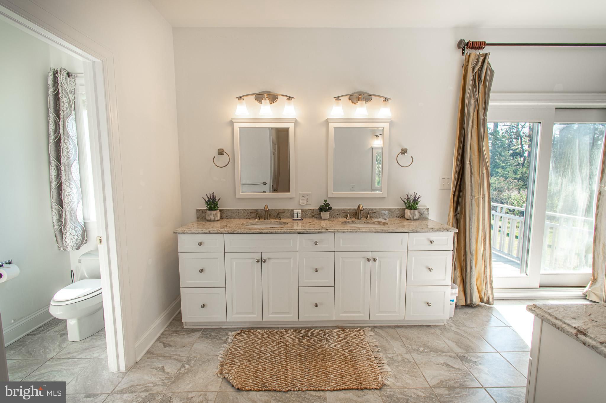 5227 Brooks Road Woolford, MD 21677 - Photo 34 of 68 a spacious bathroom with a granite countertop sink and a mirror