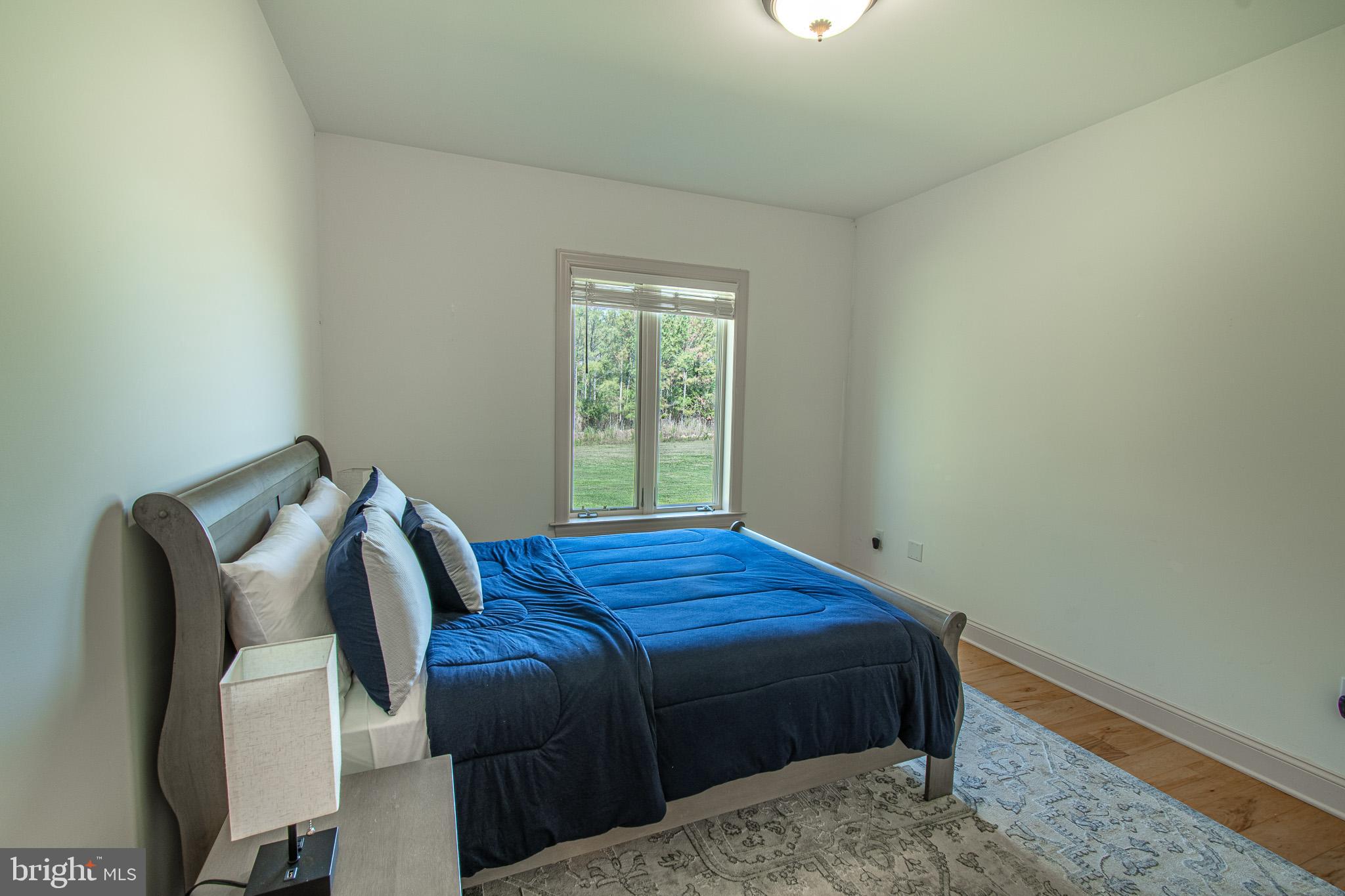 5227 Brooks Road Woolford, MD 21677 - Photo 40 of 68 a bed sitting in a bedroom next to a window