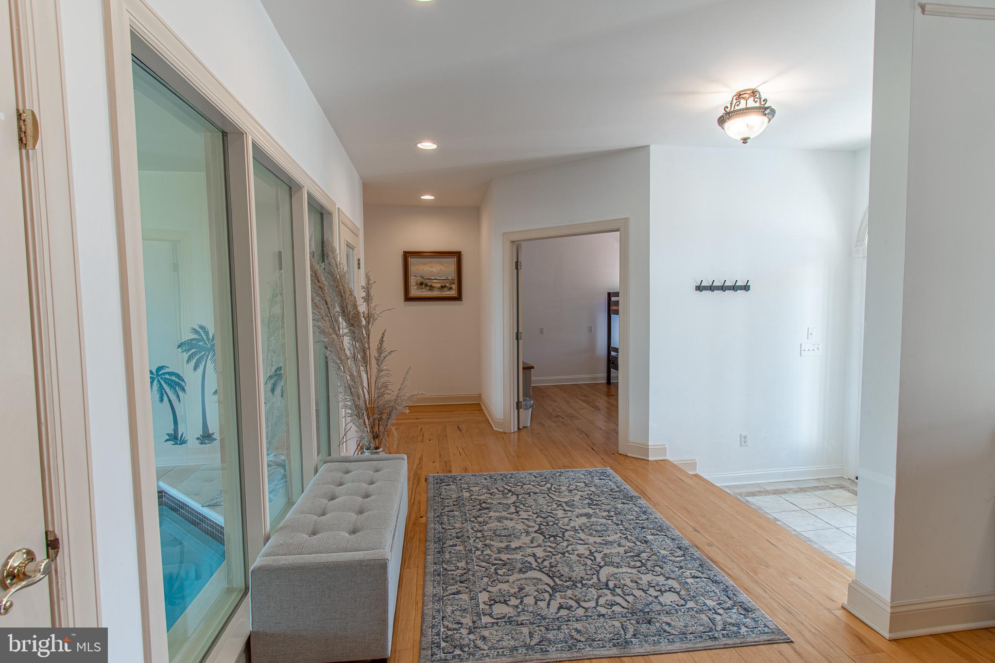 5227 Brooks Road Woolford, MD 21677 - Photo 43 of 68 a view of a hallway with bathroom and wooden floor