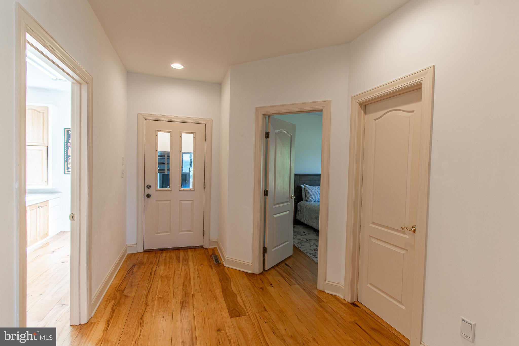 5227 Brooks Road Woolford, MD 21677 - Photo 48 of 68 a view of a hallway with wooden floor and a bathroom