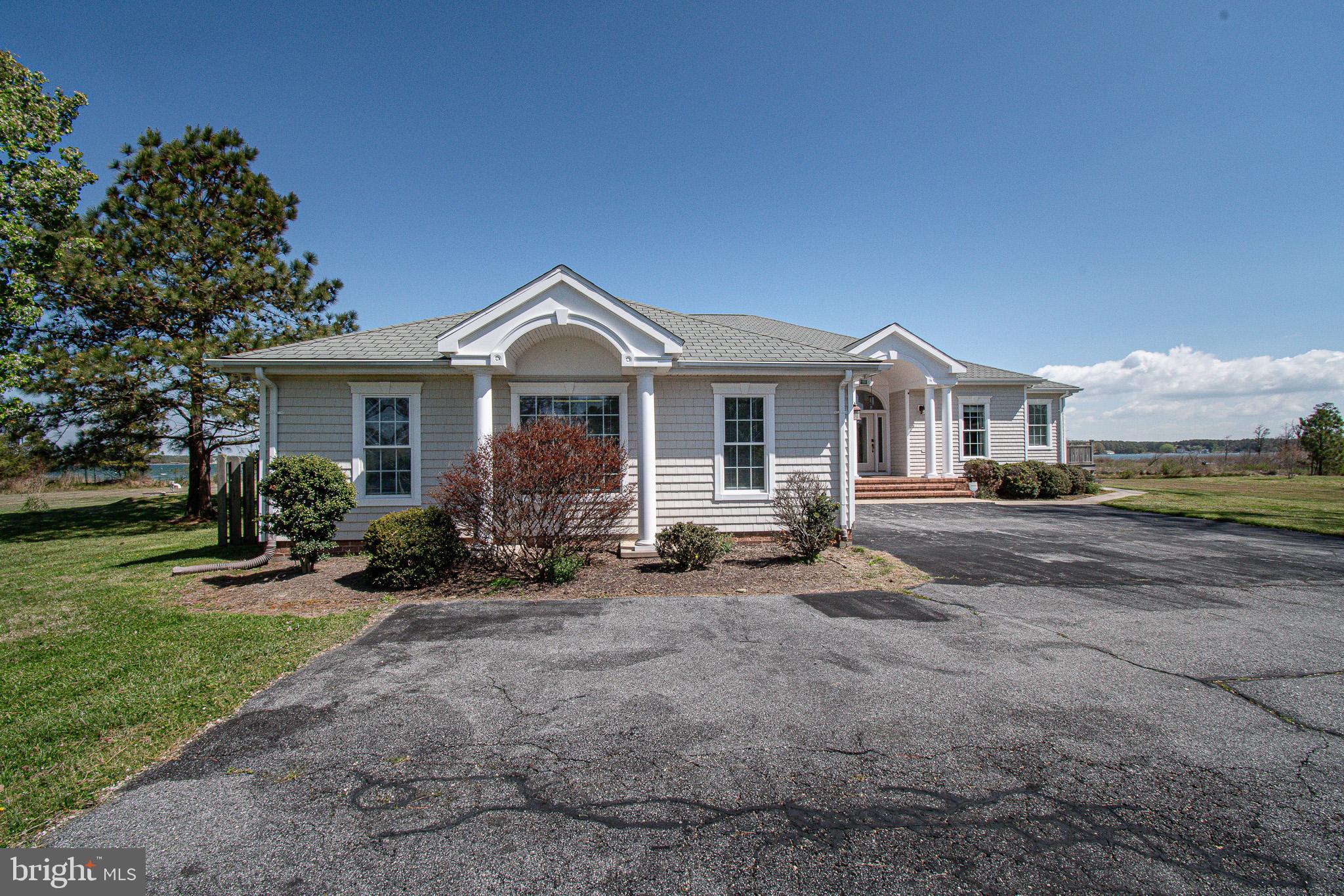 5227 Brooks Road Woolford, MD 21677 - Photo 64 of 68 a front view of a house with a garden and porch