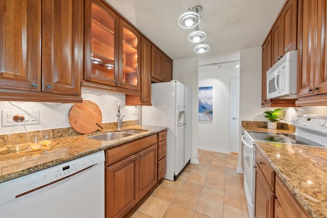 a kitchen with stainless steel appliances granite countertop a sink and cabinets