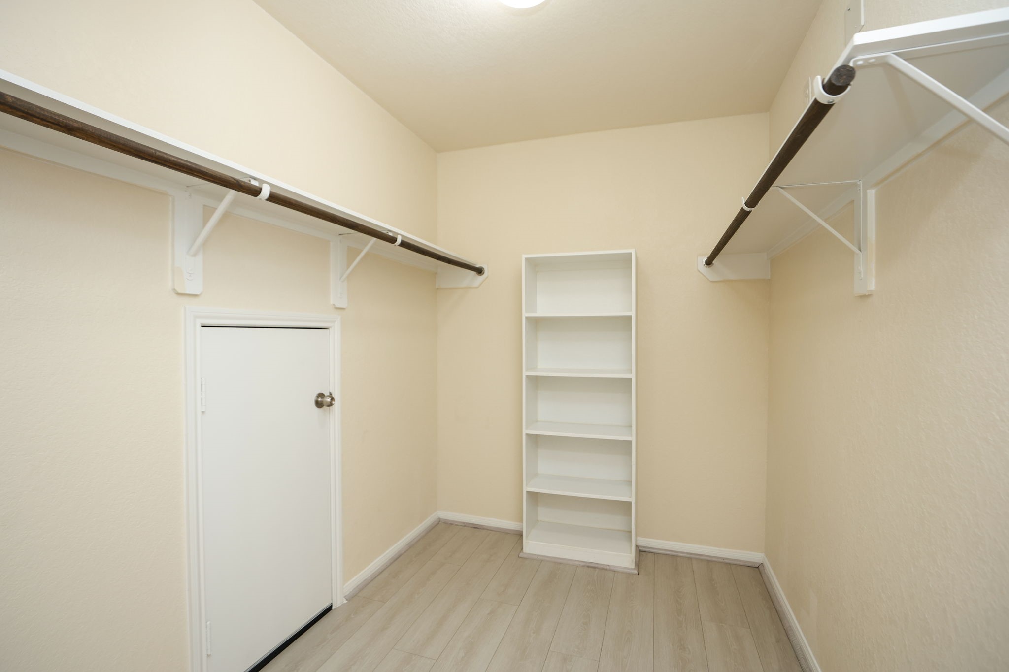 18402 Spruce Tree Line Trail Houston, TX 77084 - Photo 20 of 30 Spacious walk-in closet with light-colored walls, wood flooring, and ample shelving and hanging space for storage.
