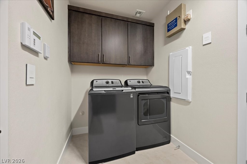4262 Swift Street Las Vegas, NV 89135 - Photo 37 of 75 Laundry area featuring cabinet space, washer and dryer, and electric panel