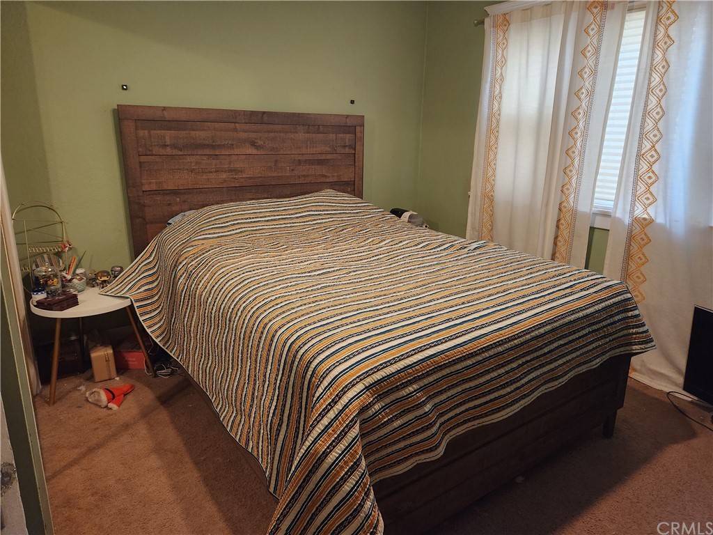 4466 11th Street Riverside, CA 92501 - Photo 11 of 17 a bedroom with a bed and a window