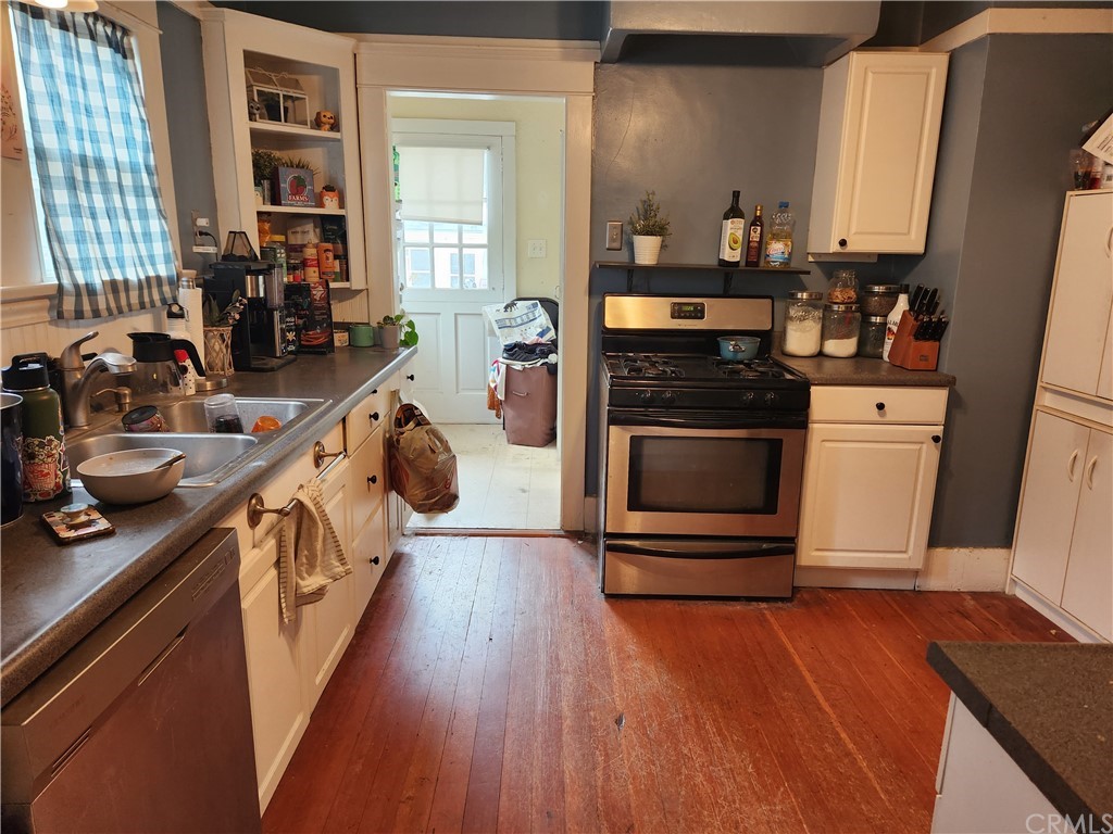 4466 11th Street Riverside, CA 92501 - Photo 8 of 17 a kitchen with stainless steel appliances granite countertop a stove and a wooden floors