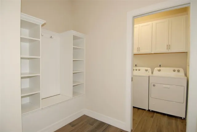 a view of a backyard with chair and potted plants
