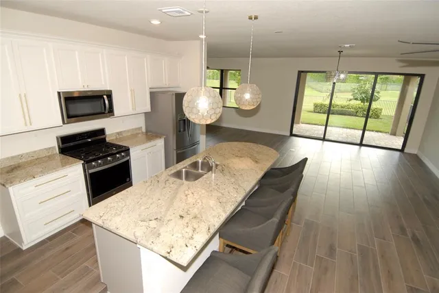 a kitchen with a wooden floor a stove and a wooden floors