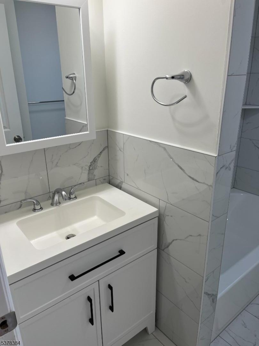 433 Rosehill Place, Unit 3 Elizabeth, NJ 07202 - Photo 2 of 13 a bathroom with a sink vanity and a mirror