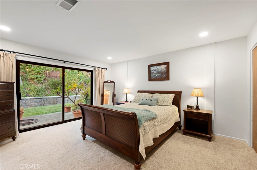3495 Ridgecrest Drive Carlsbad, CA 92008 - Photo 27 of 42 a spacious bedroom with a bed and a large window