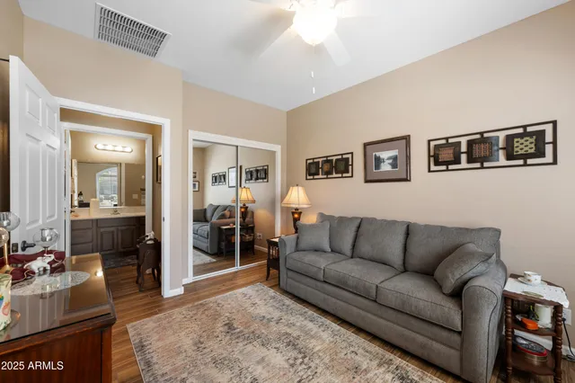 a living room with furniture and a view of kitchen