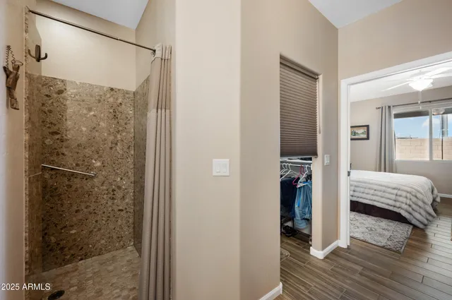 a en suite bathroom with a shower and a sink