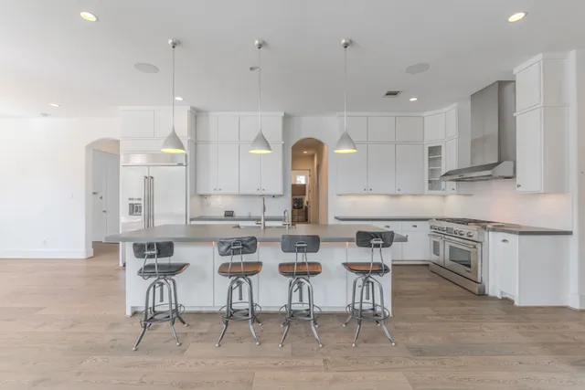 a kitchen with white cabinets sink and stainless steel appliances