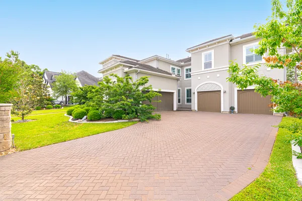 a view of a house with a swimming pool and a yard