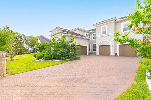 a view of a house with a swimming pool and a yard