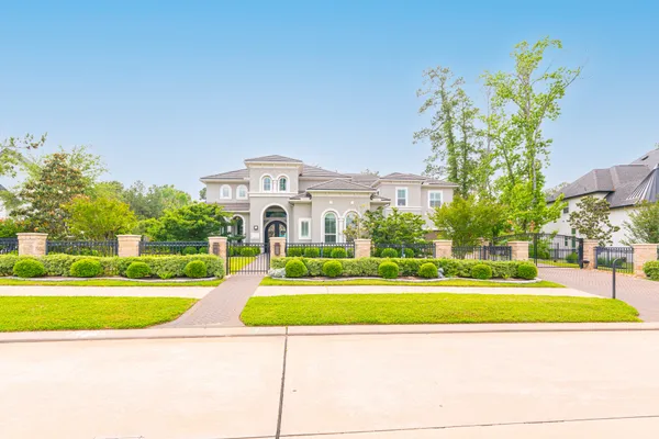 a kitchen with stainless steel appliances kitchen island granite countertop a refrigerator a sink a stove and white cabinets