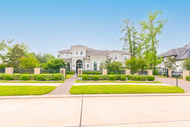 a kitchen with stainless steel appliances kitchen island granite countertop a refrigerator a sink a stove and white cabinets