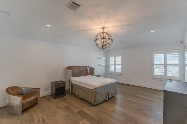 a spacious bedroom with a bed and cabinets