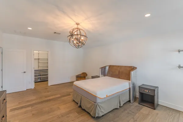 a bedroom with a large bed and a window