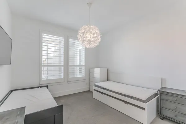 a bedroom with furniture and a large window
