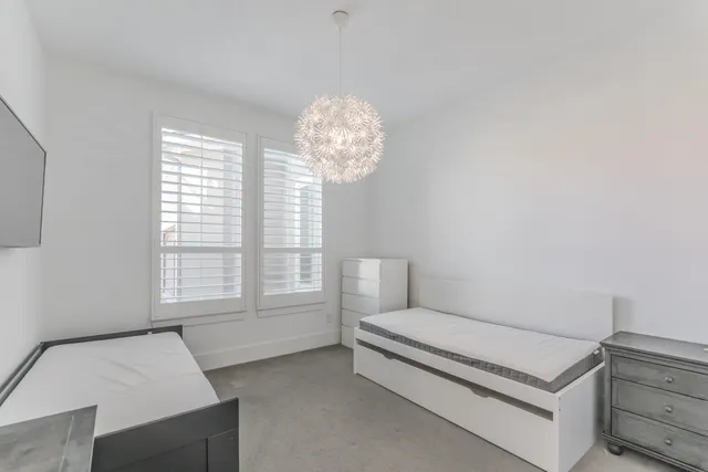 a bedroom with furniture and a large window